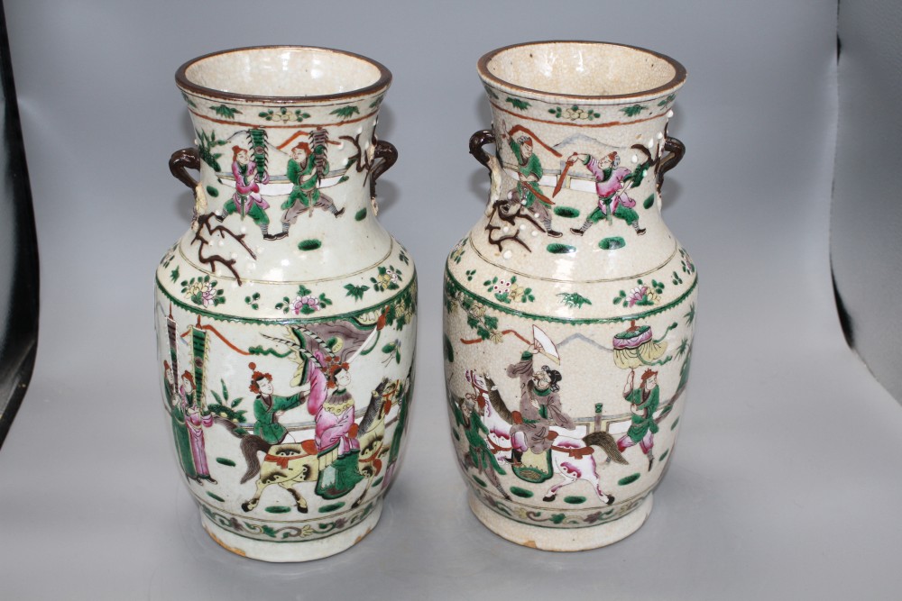 A pair of Chinese crackleware vases, decorated with figures in continuous landscapes, height 33cm